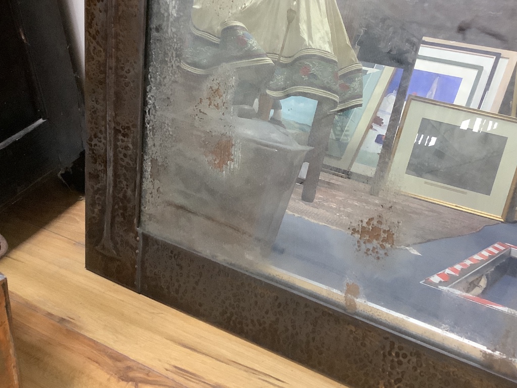 A large Art Nouveau hammered copper overmantel mirror, width 120cm, height 78cm